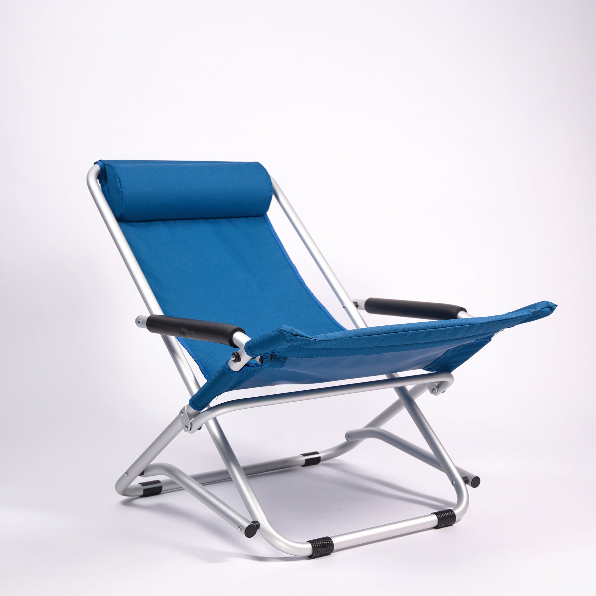 Blue folding camping chair with a white background
