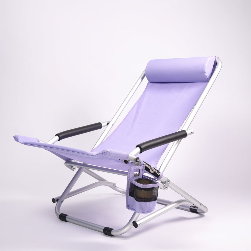 Purple folding beach chair with cup holder on a white background