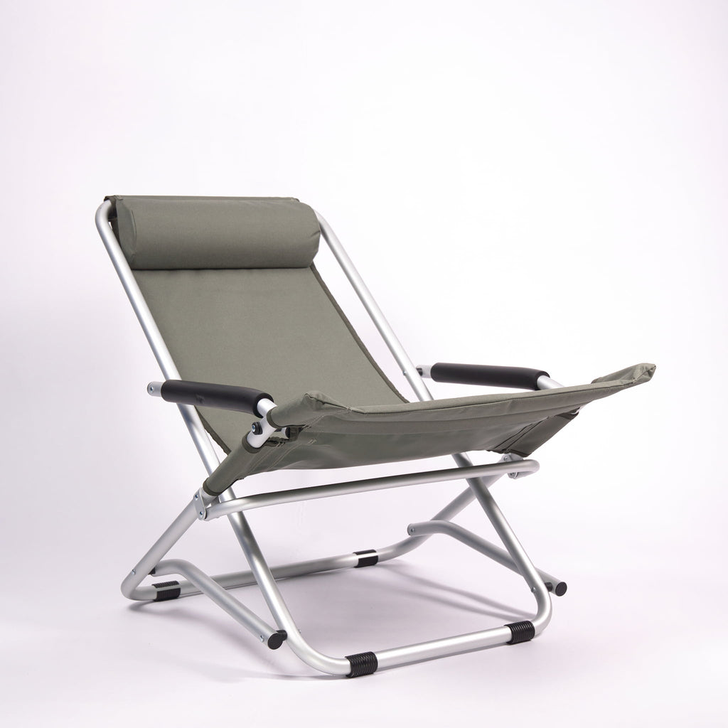 Foldable chair with green seat and backrest on a white background