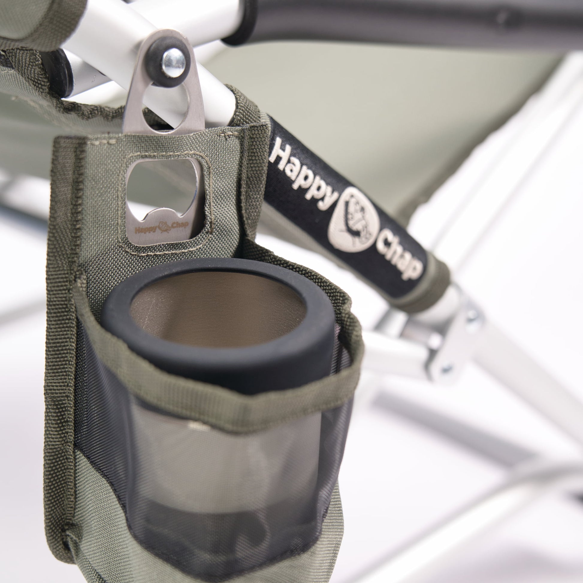 a keep cup in a detachable cup holder attached to a happy chap chair with happy chap branding