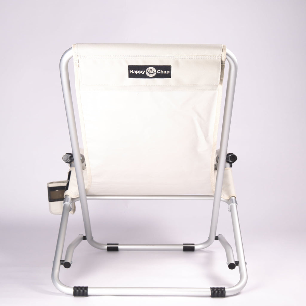 Beige folding chair with aluminium frame on a white background, featuring 'Happy Chap' branding.