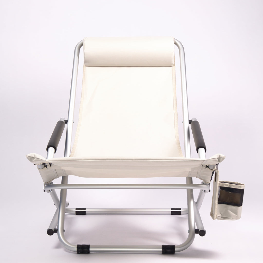 Foldable beach chair with sand-coloured seat and headrest on a white background